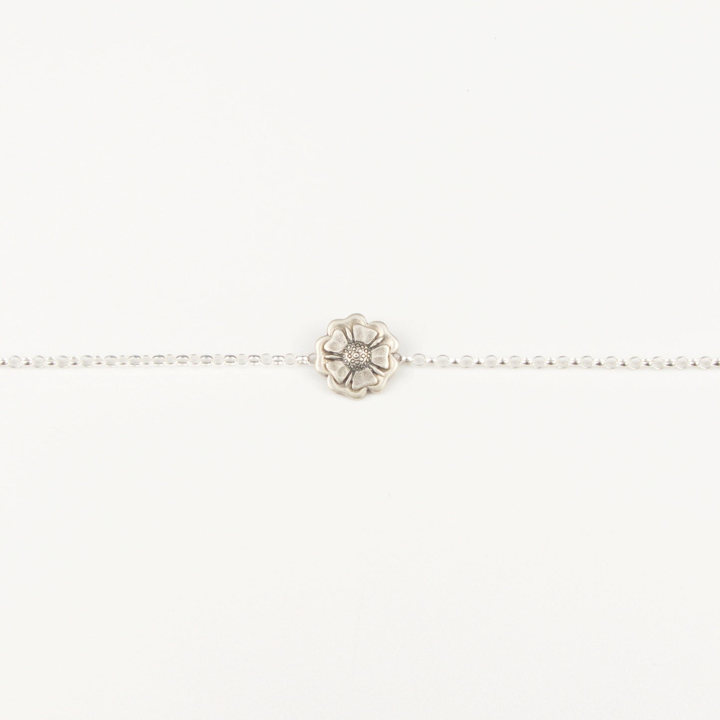 Outlander Jacobite Rose Coin Collection single charm bracelet with rose charm on a white background with rose by Aurora Jewellery, Orkney, Scotland
