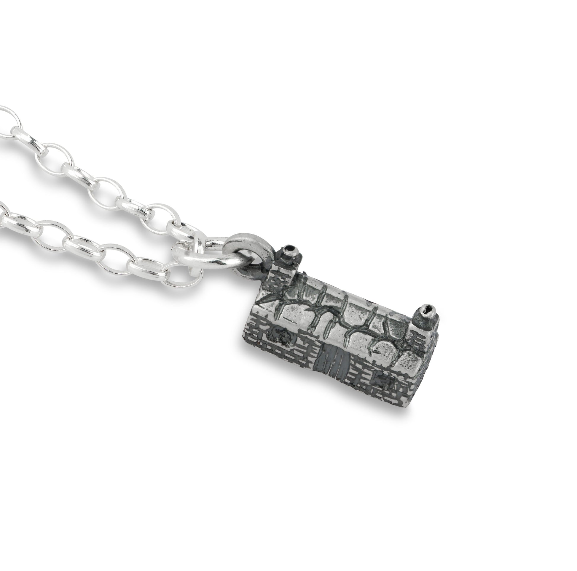 Silver necklace with a cottage pendant on a white background