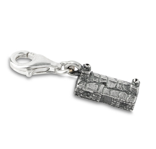 Silver charm with lobster clasp fitting shaped like a cottage on a white background