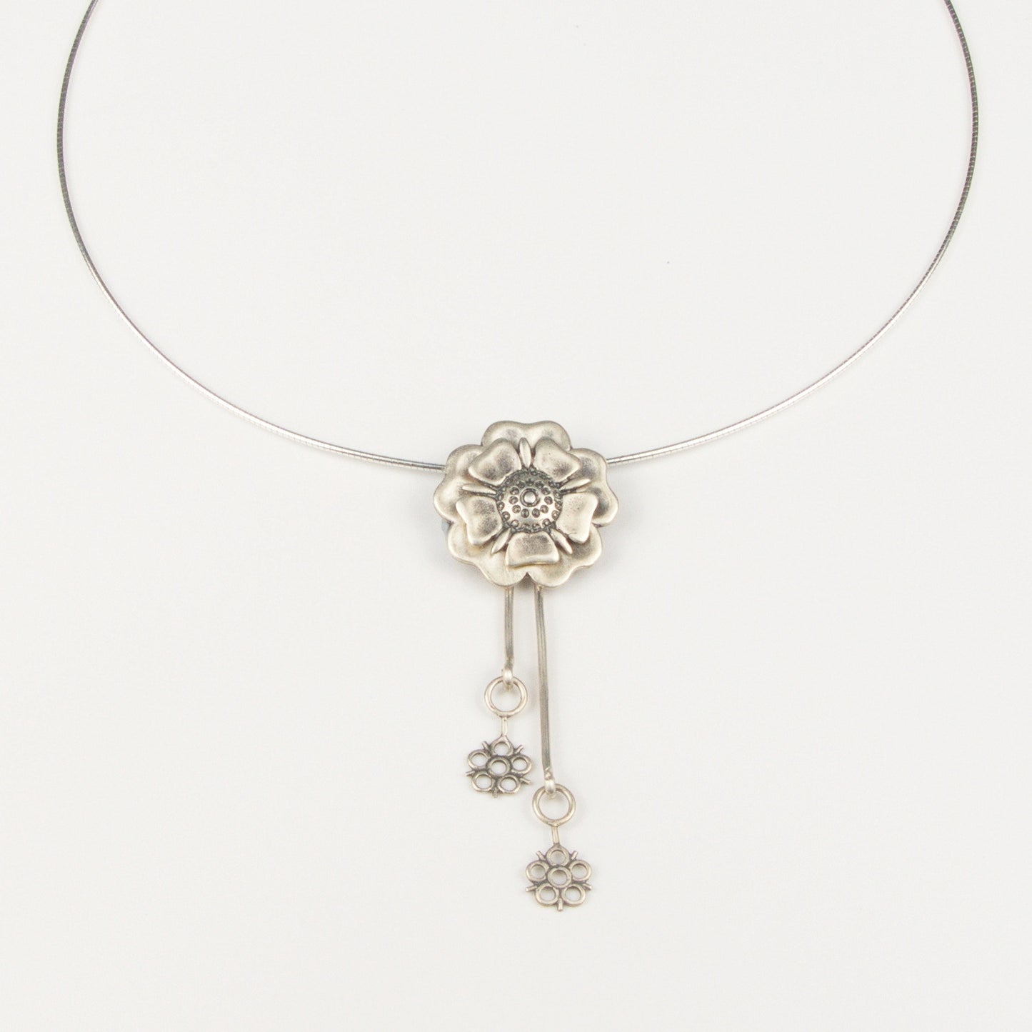 Outlander Jacobite Rose Coin Collection necklace with rose charm and drop detail on a white background with rose by Aurora Jewellery, Orkney, Scotland
