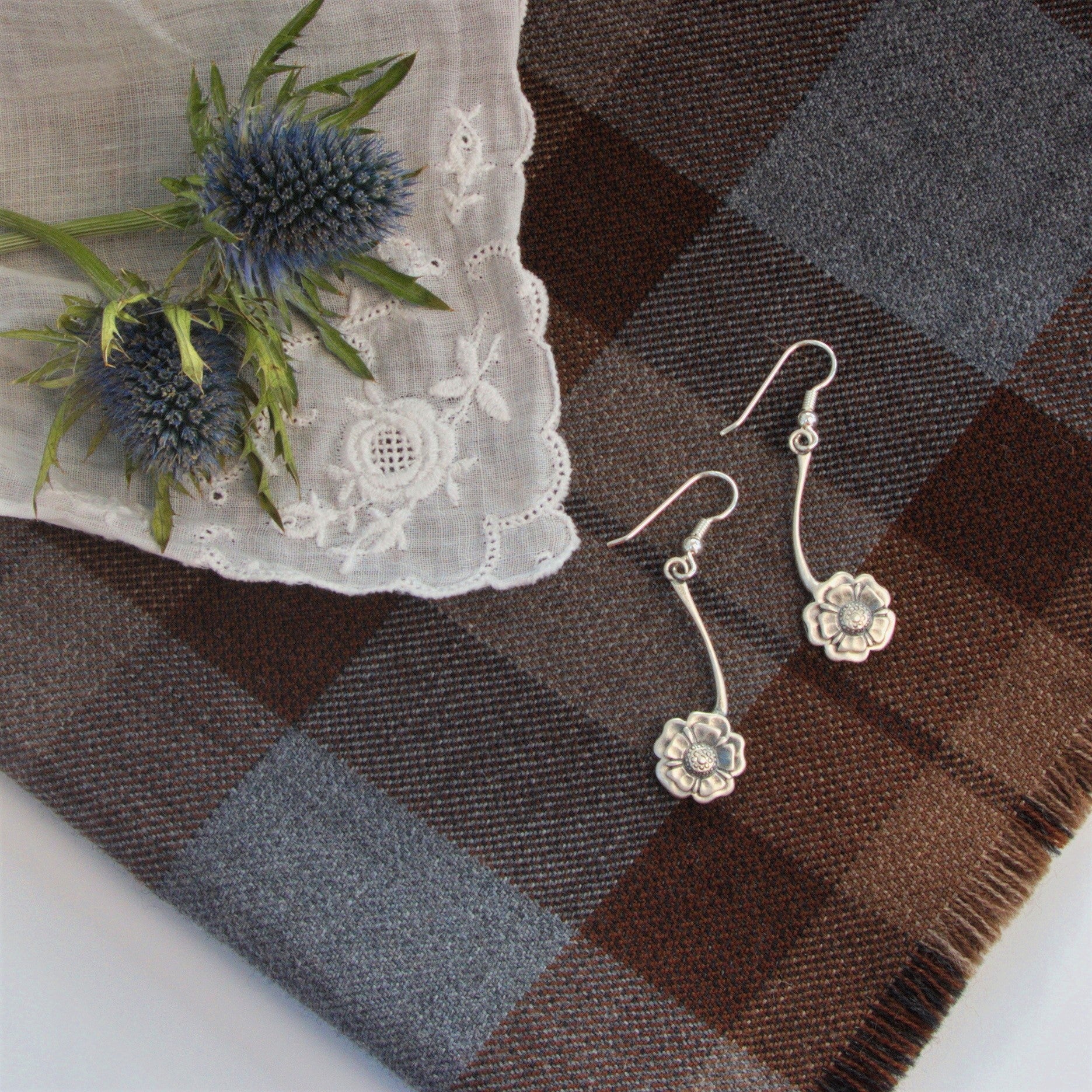 Outlander Rose Coin Collection drop earrings on a slate background with rose, made by Aurora Jewellery, Orkney, Scotland