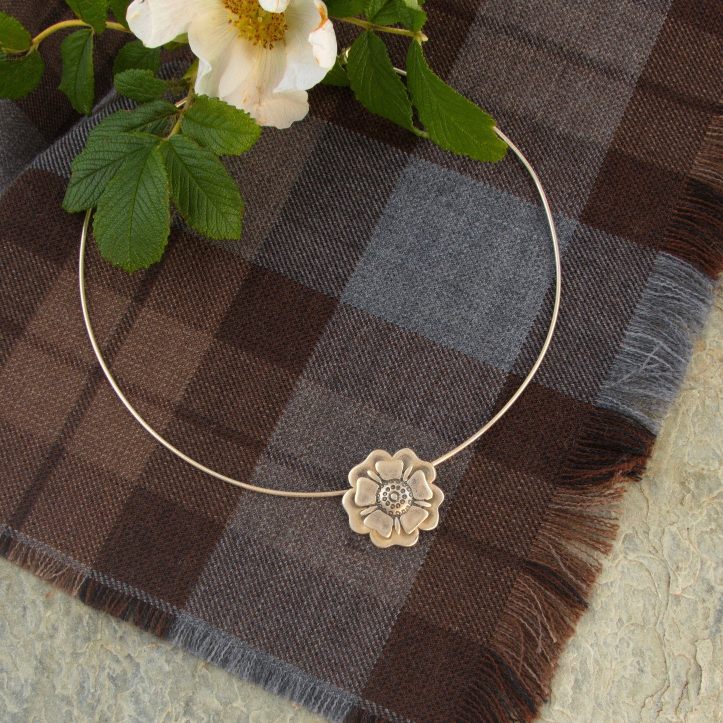 Outlander Jacobite Rose Coin Collection necklace with rose charm on a tartan background with rose by Aurora Jewellery, Orkney, Scotland