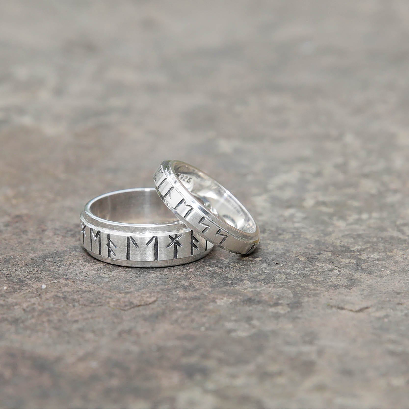 Celtic wedding rings Runic Ring 4mm Silver 16032-1 -  displayed on stone Aurora Orkney Jewellery
