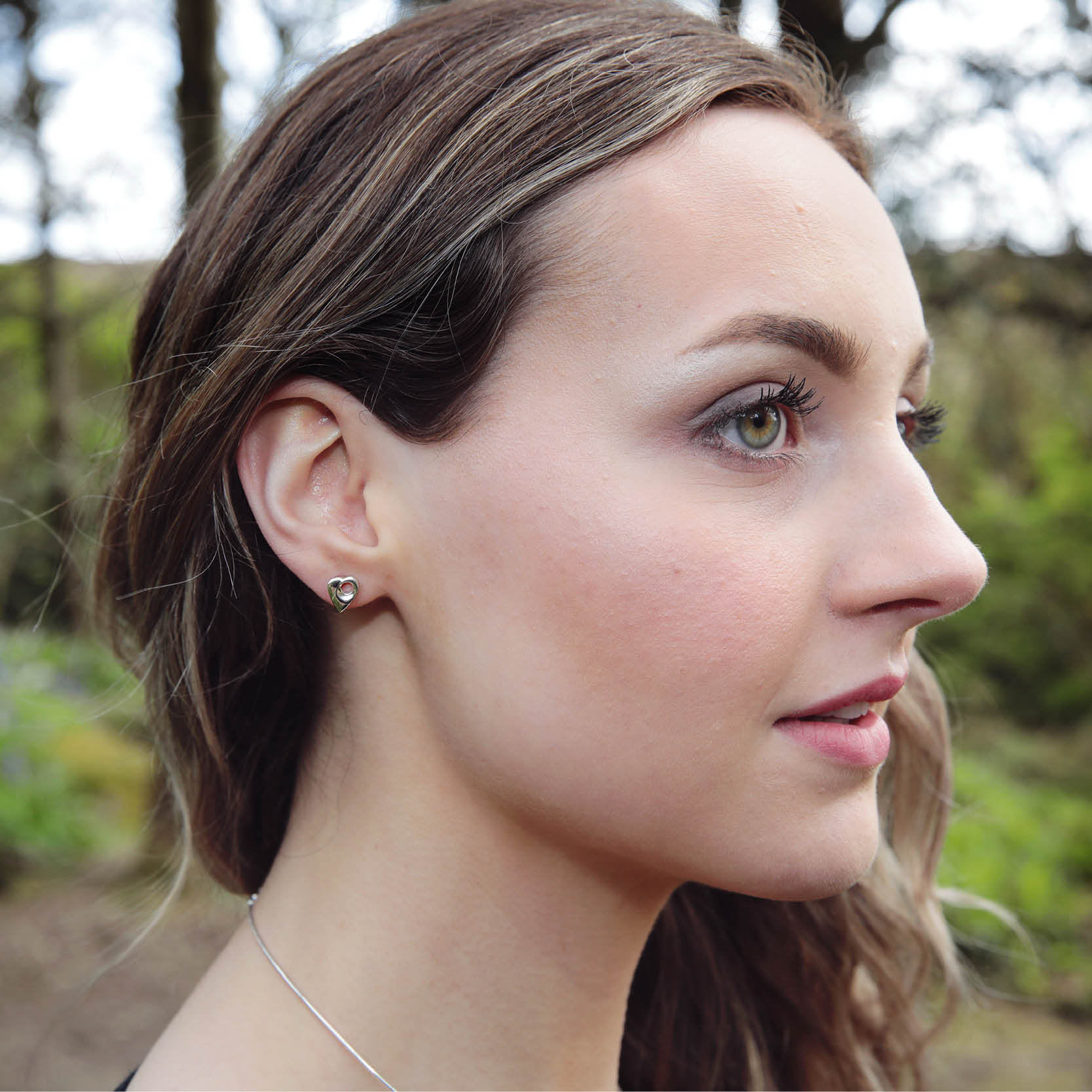 Model wearing Sterling Silver, Crest stud earring,  Aurora Orkney Jewellery, Orkney, Scotland