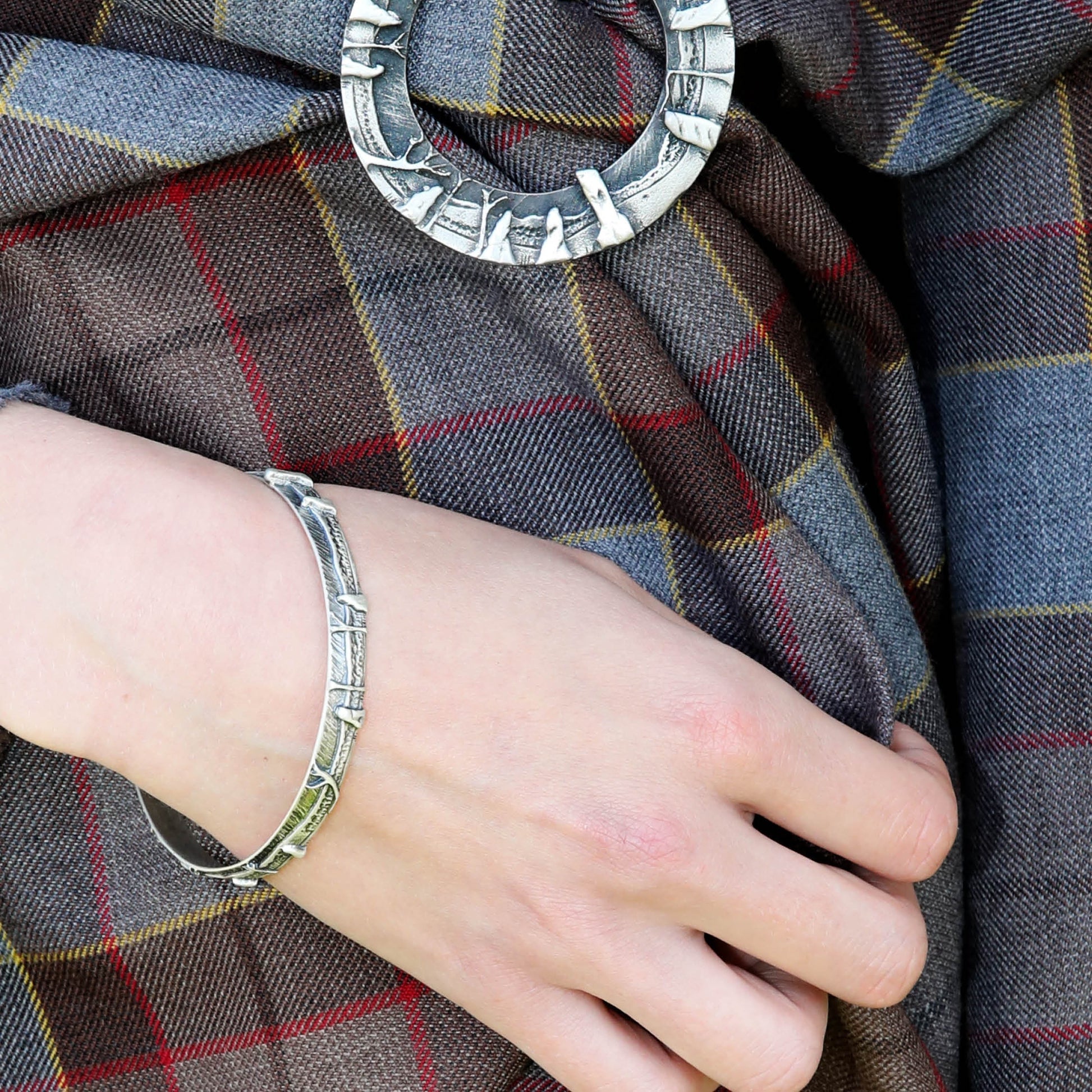 Based on the Craigh na Dun stone circle featured in the Outlander TV series,  This celtic jewelry bangle in sterling silver, by Aurora Jewellery Orkney, Scotland